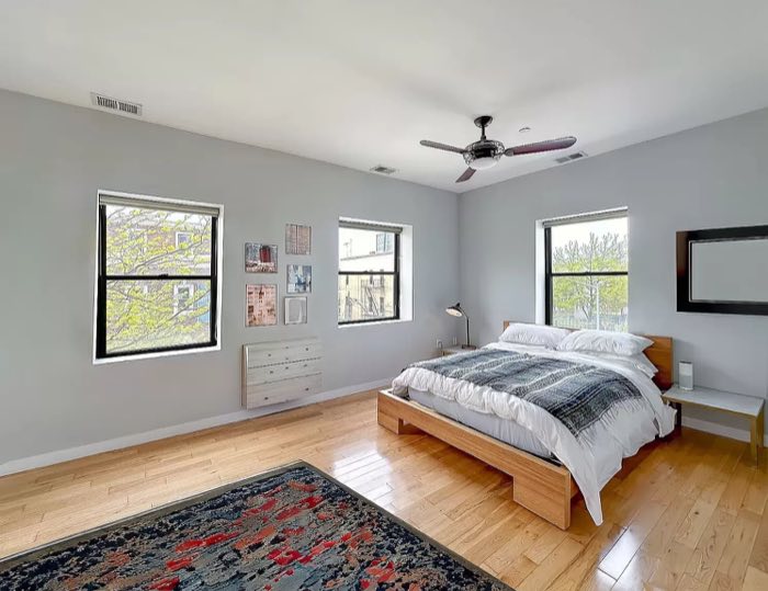 Main bedroom with windows on two walls